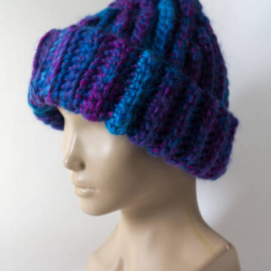 Knitted hat "hand made" is worn on the head of a dummy