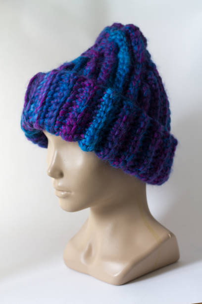Knitted hat "hand made" is worn on the head of a dummy